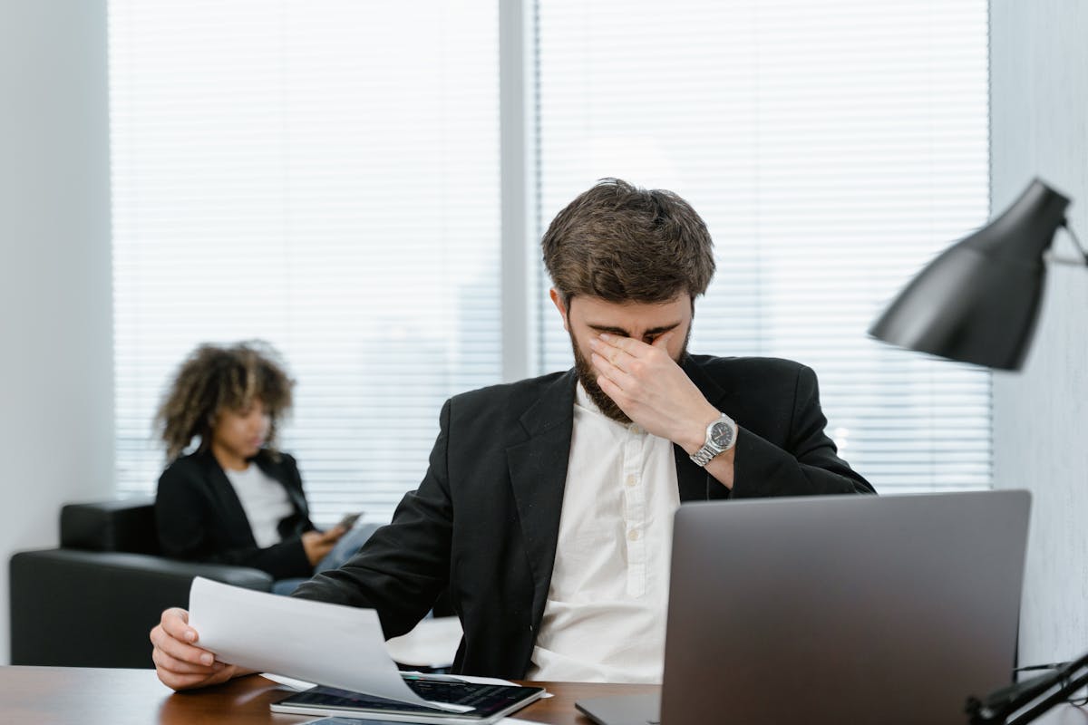 A Man in Black Suit Jacket Using a Laptop