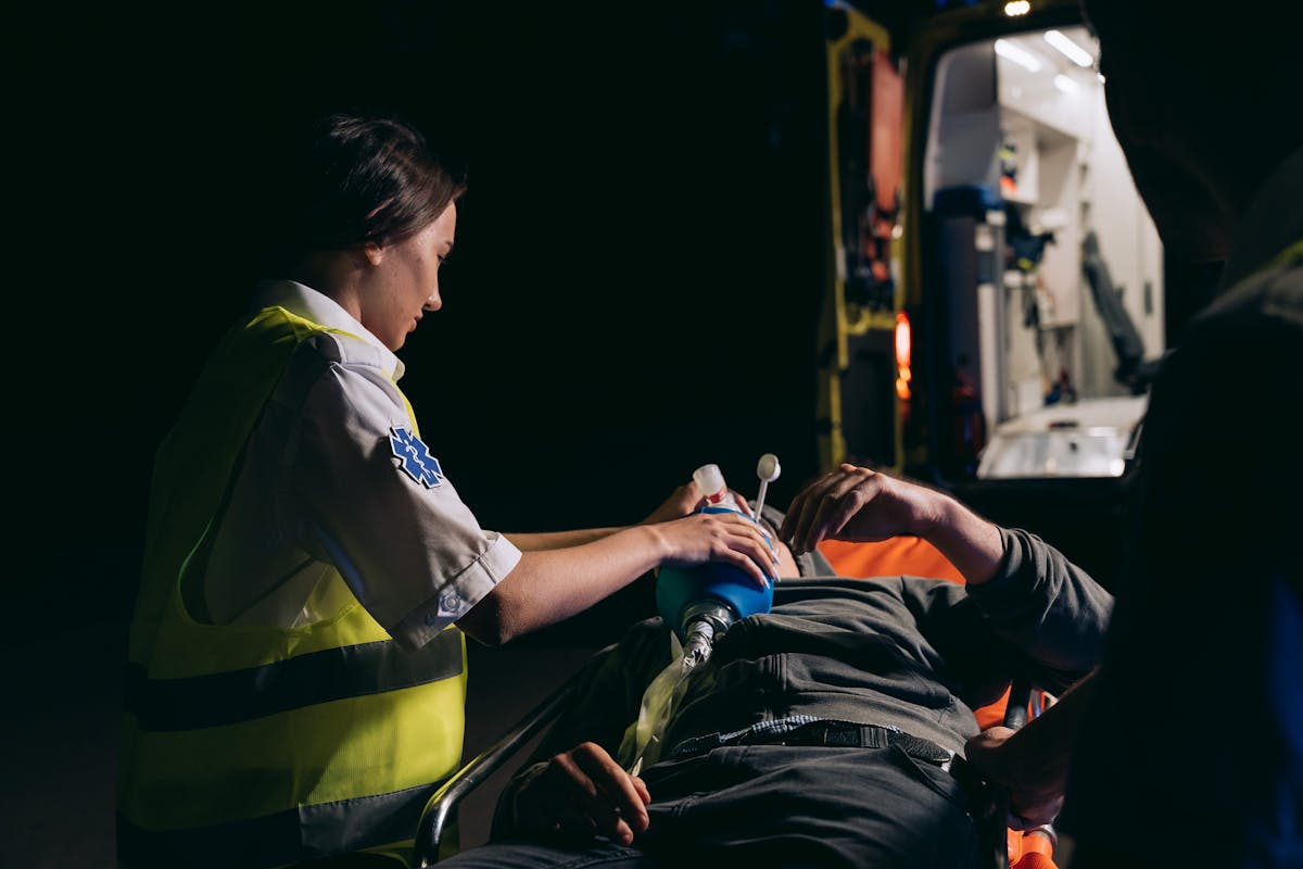 A Person in Neon Yellow Vest Giving First Aid to a Person