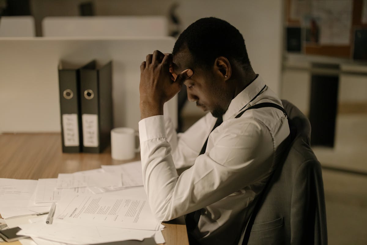 Man Staying Up Late in Office Working on Papers