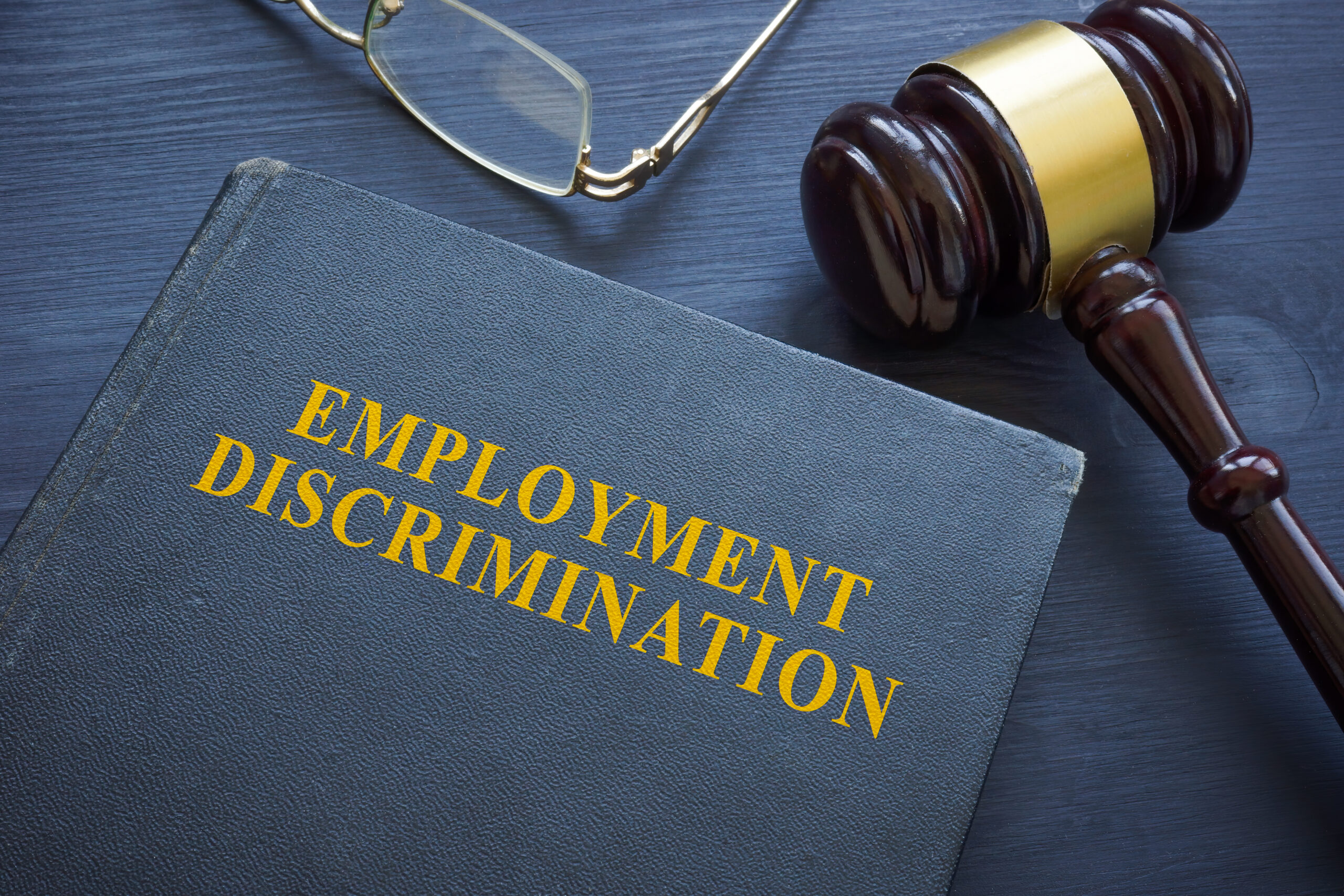Law about employment discrimination and a gavel on the table.