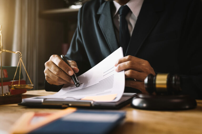 justice and law concept.Male judge in a courtroom on wooden table and Counselor or Male lawyer working in office. Legal law, advice and justice concept.